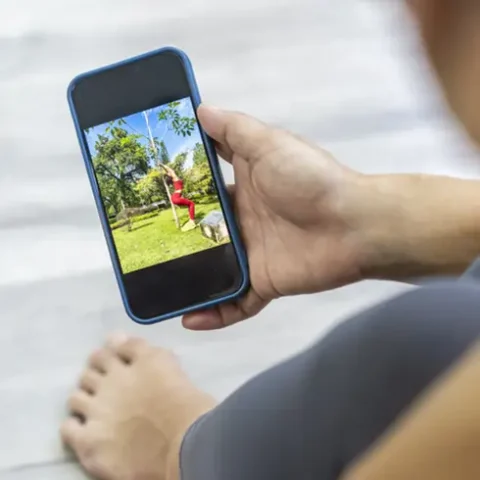 watching workout video on mobile phone